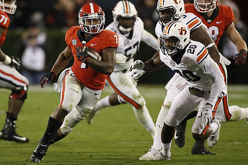 Georgia tailback D'Andre Swift (7) ran for 186 yards against Auburn last week and can take aim at his fourth straight 100-yard rushing performance when the Bulldogs host UMass on Saturday.