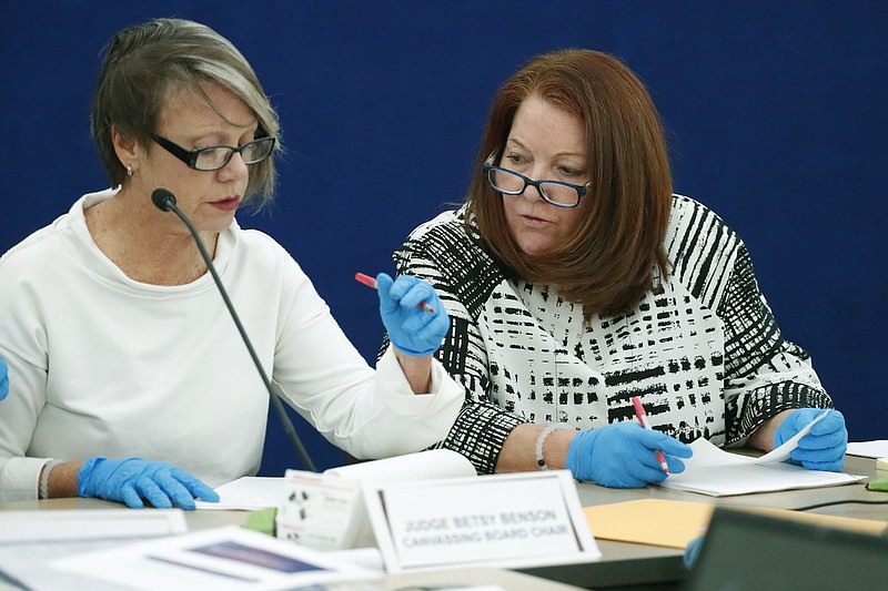 Canvassing Board chair Judge Betsy Benson, left, and board member Judge Deborah Carpenter-Toye, examine ballots with over or under votes after a hand recount on Friday in Lauderhill, Fla. (AP Photo/Wilfredo Lee)