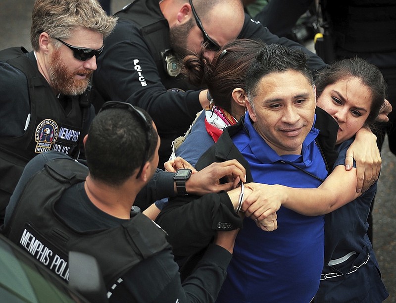 In this April 3, 2018 photo, Memphis police arrest Spanish-language reporter Manuel Duran during an immigration protest in Memphis, Tenn. Duran, who faces deportation after his arrest while covering the protest in Tennessee said Tuesday, Nov. 13 he was unjustly detained and faces danger if sent back to El Salvador. Duran spoke publicly about his case for the first time since his arrest at the April rally protesting immigration policies the day before the 50th anniversary of the assassination of civil rights leader Martin Luther King Jr. in downtown Memphis. (Jim Weber/The Commercial Appeal via AP)

