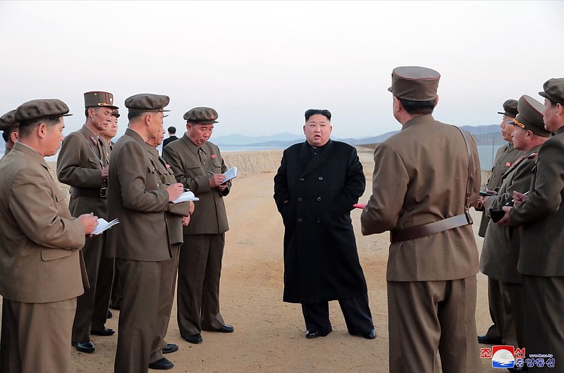 In this undated photo released Friday, Nov. 16, 2018, by the North Korean government, North Korean leader Kim Jong Un, center, listens to a military official as he inspects a weapon testing at the Academy of National Defense Science, North Korea. Kim observed the successful test of a "newly developed high-tech tactical" weapon, the nation's state media reported Friday, Nov. 16, 2018, though it didn't describe what sort of weapon it was. Independent journalists were not given access to cover the event depicted in this image distributed by the North Korean government. The content of this image is as provided and cannot be independently verified. Korean language watermark on image as provided by source reads: "KCNA" which is the abbreviation for Korean Central News Agency. (Korean Central News Agency/Korea News Service via AP)

