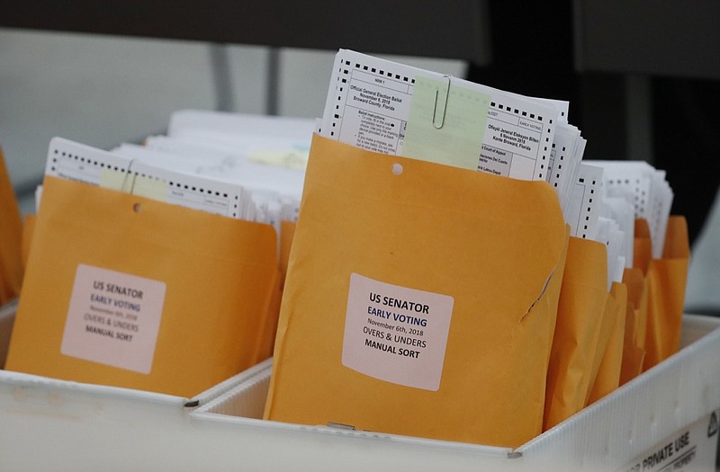 Boxes of over and under ballots waiting to be examined at the Broward County Supervisor of Elections office are shown during a hand recount, Friday, Nov. 16, 2018, in Lauderhill, Fla. Florida's bitter U.S. Senate contest is headed to a legally required hand recount after an initial review by ballot-counting machines showed Republican Gov. Rick Scott and Democratic Sen. Bill Nelson separated by less than 13,000 votes. (AP Photo/Wilfredo Lee)