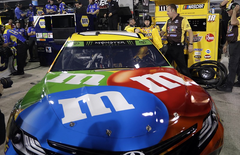 Kyle Busch gets into his car during qualifying Friday at Homestead-Miami Speedway for Sunday's NASCAR Cup Series race.