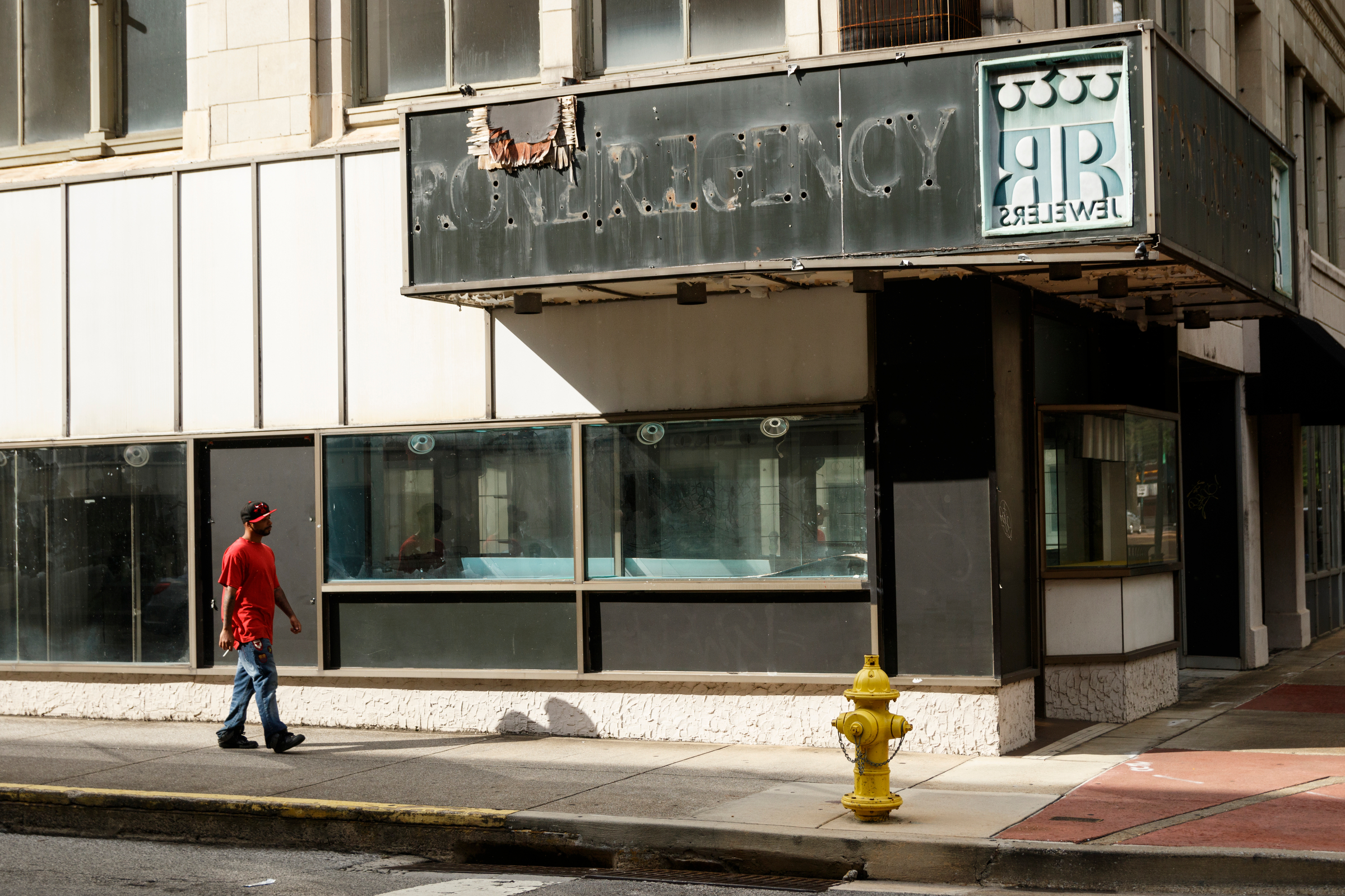 A person walks past a vacant storefront at West 8th Street and Market Street on Tuesday, Oct. 2, 2018, in Chattanooga, Tenn.