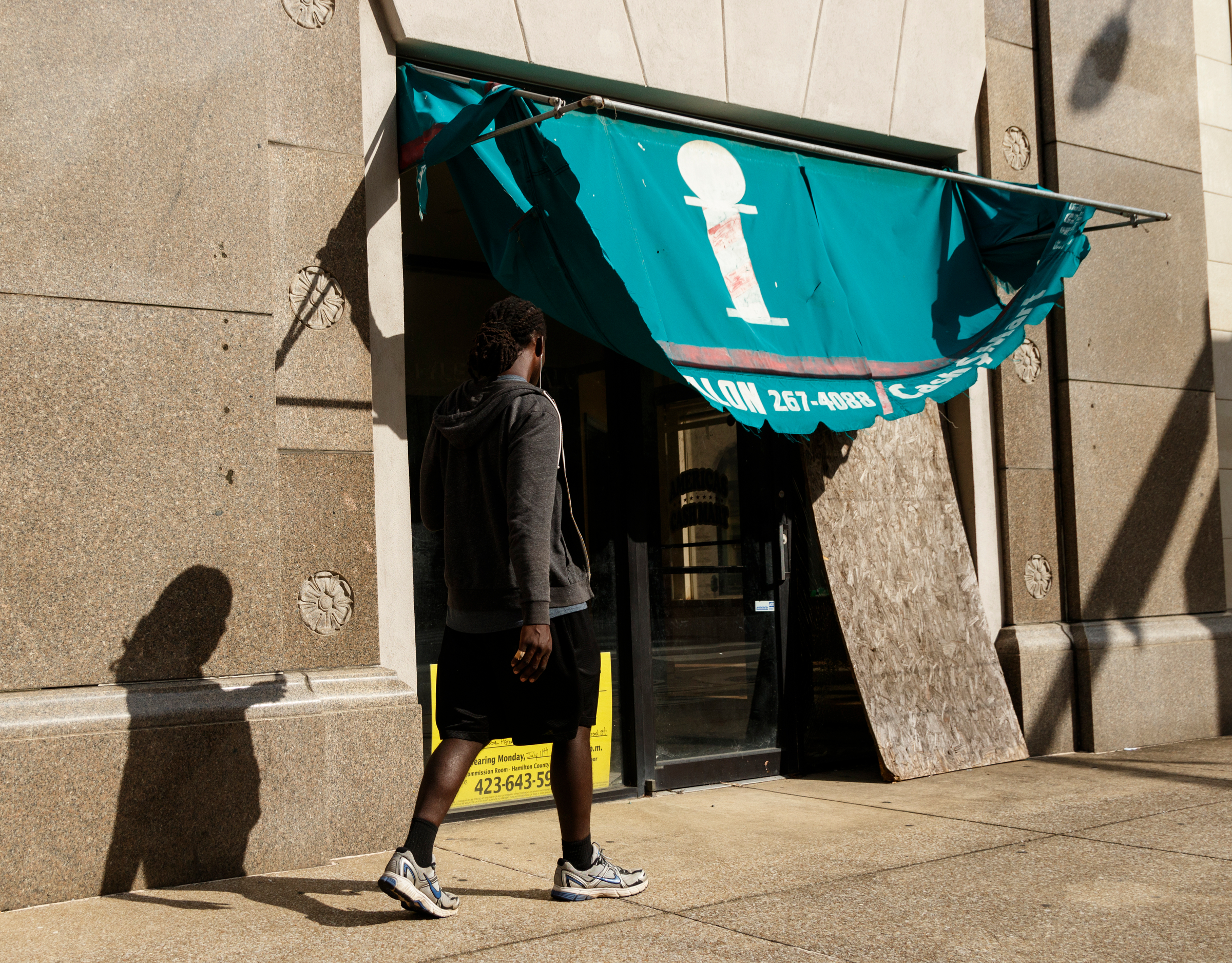 A person walks past a vacant storefront on Broad Street on Tuesday, Oct. 2, 2018, in Chattanooga, Tenn.