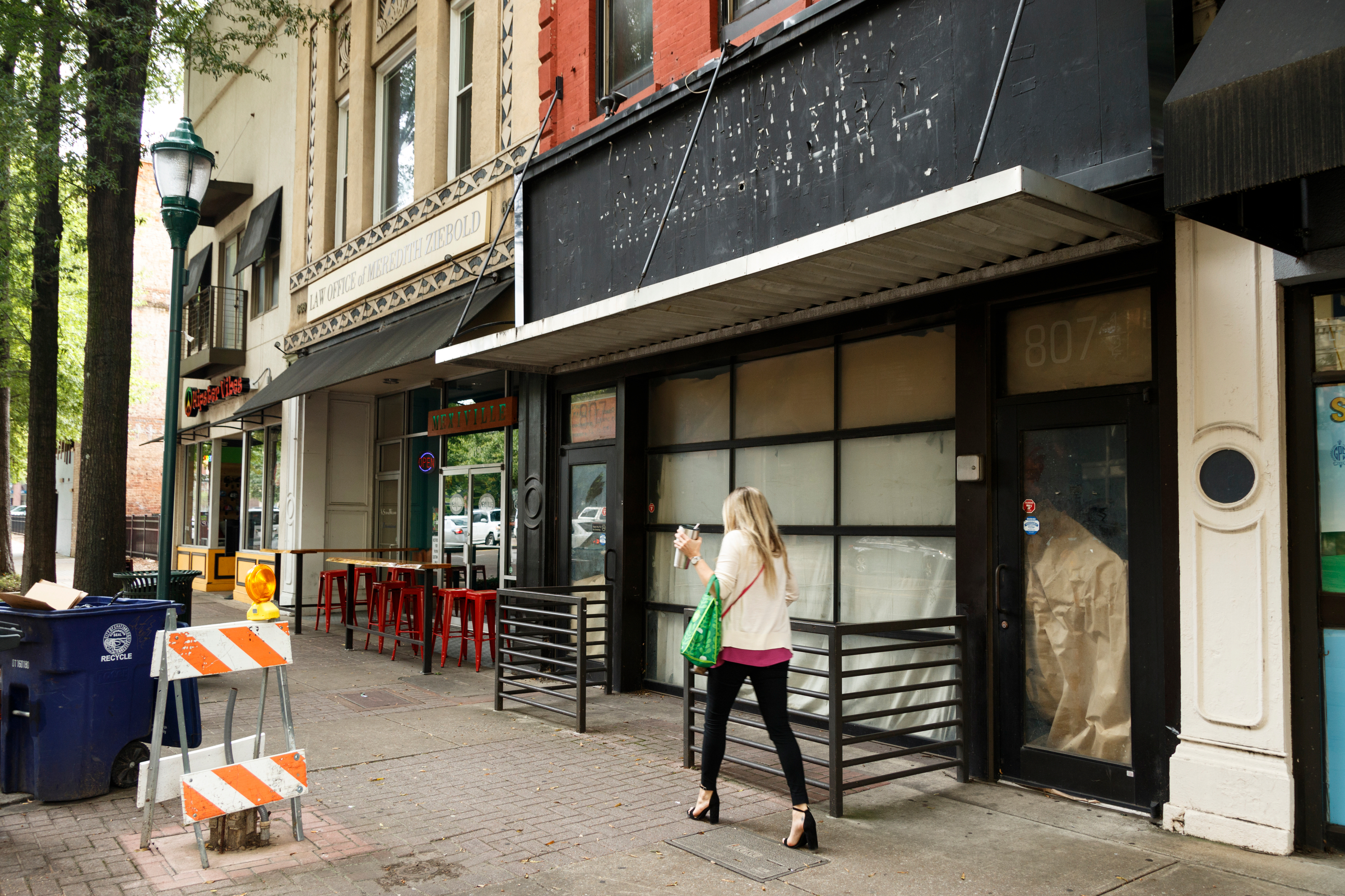 A person walks past a vacant storefront on Market Street on Tuesday, Oct. 2, 2018, in Chattanooga, Tenn.