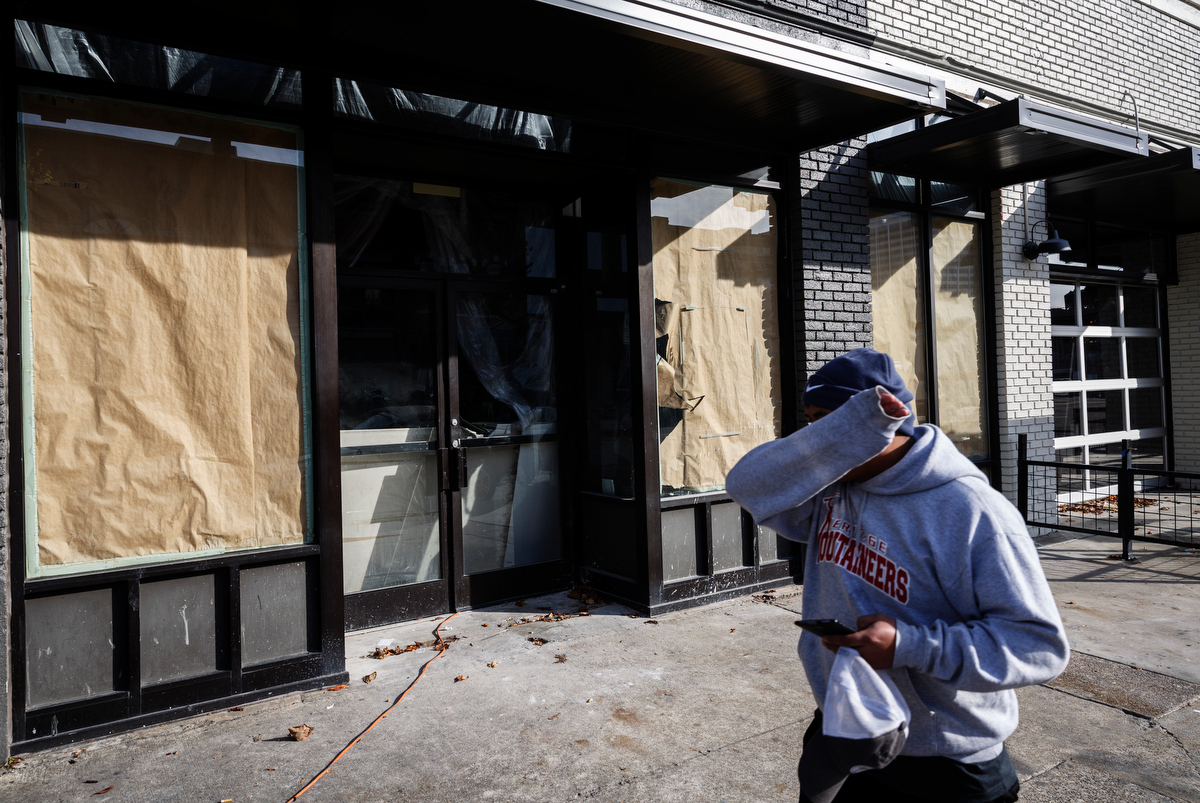 A person walks past a shuttered business on Market Street downtown on Friday, Nov. 16, 2018, in Chattanooga, Tenn.