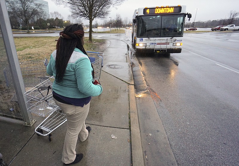 Chiquita Martin waits for the bus to begin her journey home after finishing her workday at the Brainerd Walmart on Jan. 22, 2016. Martin said it takes an average of two hours each way and a number of line changes to commute from her Alton Park residence to work using CARTA's bus system.