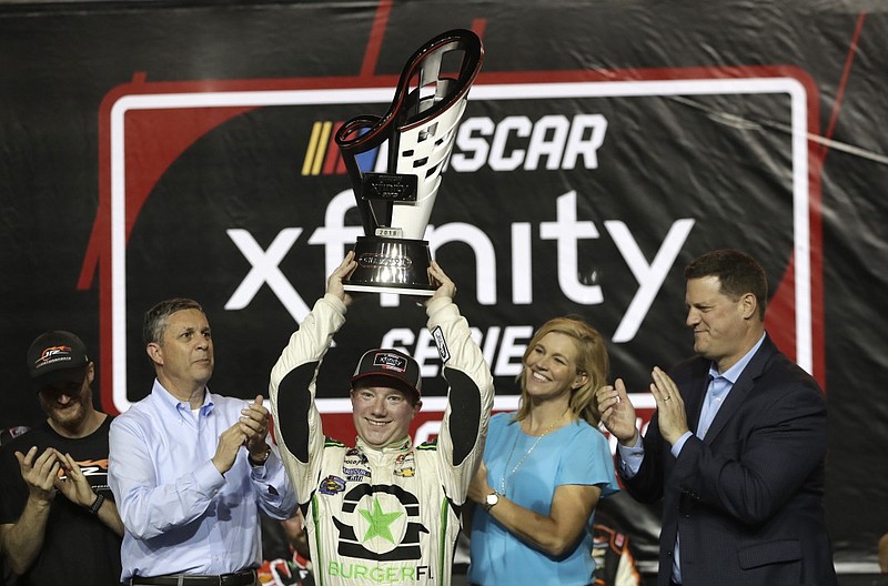 Tyler Reddick raises the trophy after winning Saturday's NASCAR Xfinity Series race at Homestead-Miami Speedway. He also secured the season points championship in the finale.