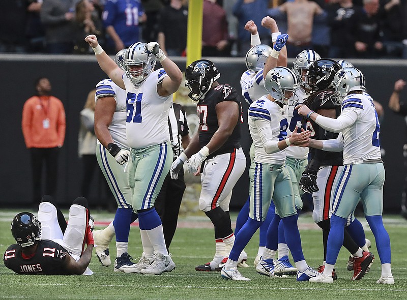 Dallas Cowboys kicker Brett Maher (2) and his teammates celebrate his game-winning 42-yard field goal as time expired in their 22-19 victory over the host Atlanta Falcons on Sunday. Atlanta's Julio Jones lies on the ground after trying to block the kick.