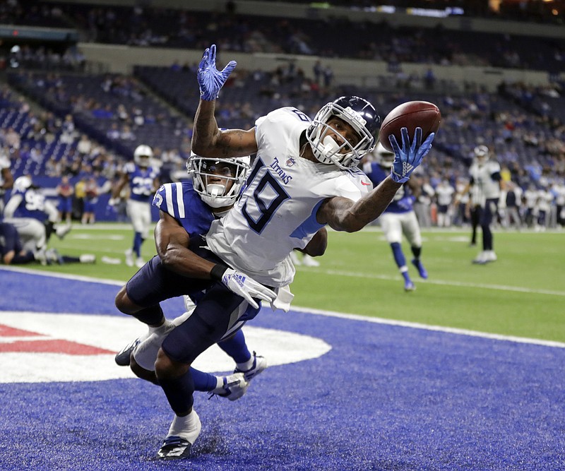 Tennessee Titans receiver Tajae Sharpe makes a touchdown catch while in the grasp of Indianapolis Colts cornerback Kenny Moore during the final minutes of Sunday's game in Indianapolis. The Colts won 38-10 for their fourth straight victory this season, while the Titans lost for the fourth time in six games.