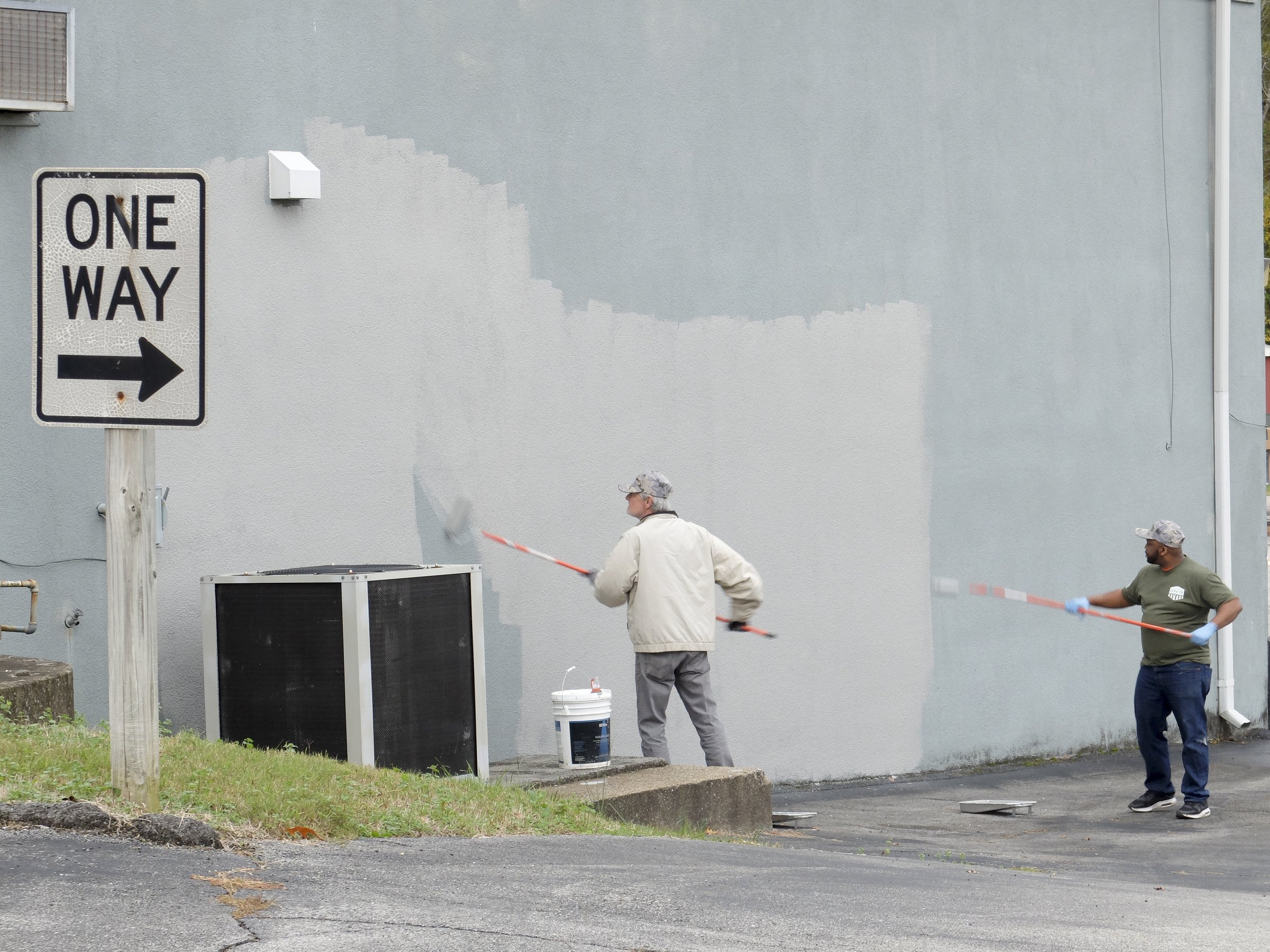 Rick McDowell, left, and Marvin Parks paint an exterior wall at VFW Post 1289. McDowell is from the Scottsboro, Ala., Home Depot store, and Parks represents the Gunbarrel store in Chattanooga.