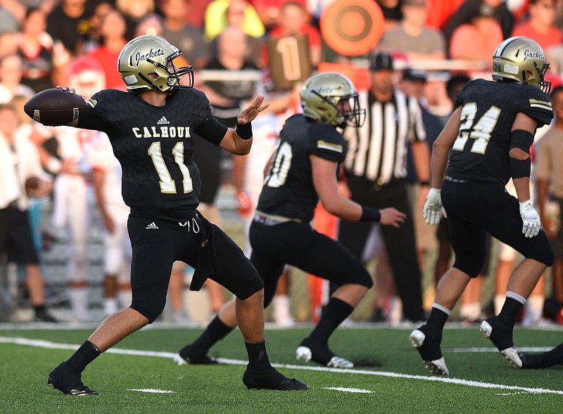 Calhoun quarterback Gavin Gray (11) throws from behind protection.  The Dalton Catamounts visited the Calhoun Yellow Jackets in GHSA high school football action on August 25, 2017. 