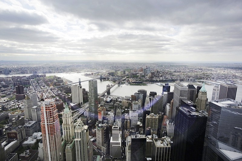 This May 20, 2015, file photo, shows New York's Financial District, foreground, the Brooklyn Bridge and East River, center, and in the distance Brooklyn as seen from the observatory at One World Trade Center. Some of the industries that have defined New York City and the Washington area will face increased competition for talent when Amazon sets up shop in their territory, with plans to hire 50,000 new workers amid the tightest job market in decades. (AP Photo/Mark Lennihan, File)