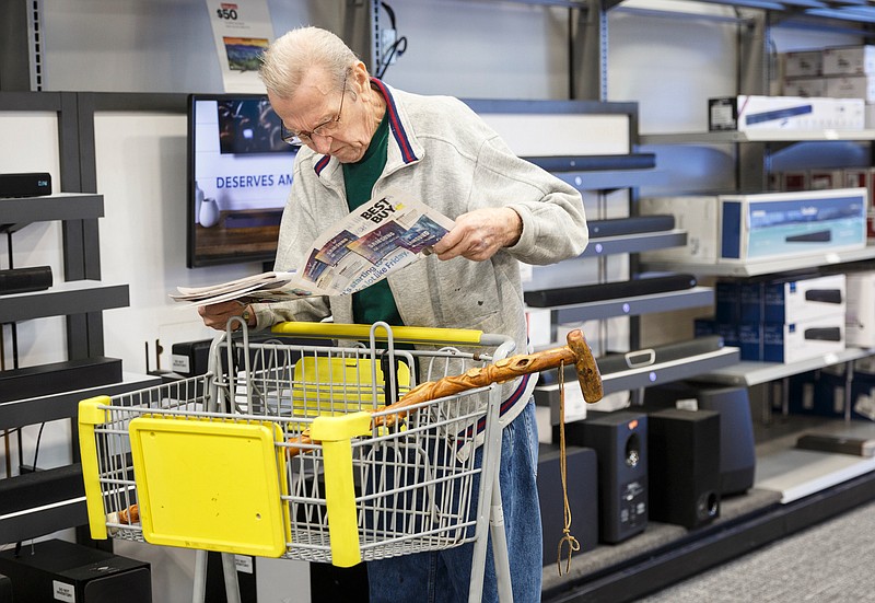 Bud Hageman looks at a sale insert while shopping at Best Buy on Tuesday, Nov. 20, 2018, in Chattanooga, Tenn. Area retailers are preparing for Black Friday shopping.