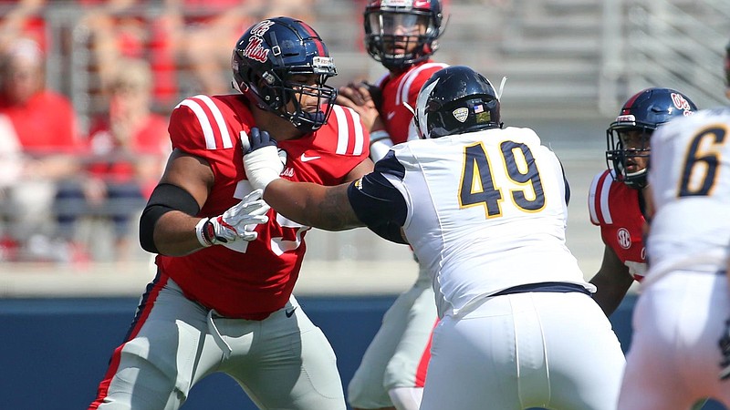 Left guard Javon Patterson (79) and quarterback Jordan Ta'amu, background, elected to stay at Ole Miss and play out their senior seasons even though there was no SEC title or bowl game at stake.