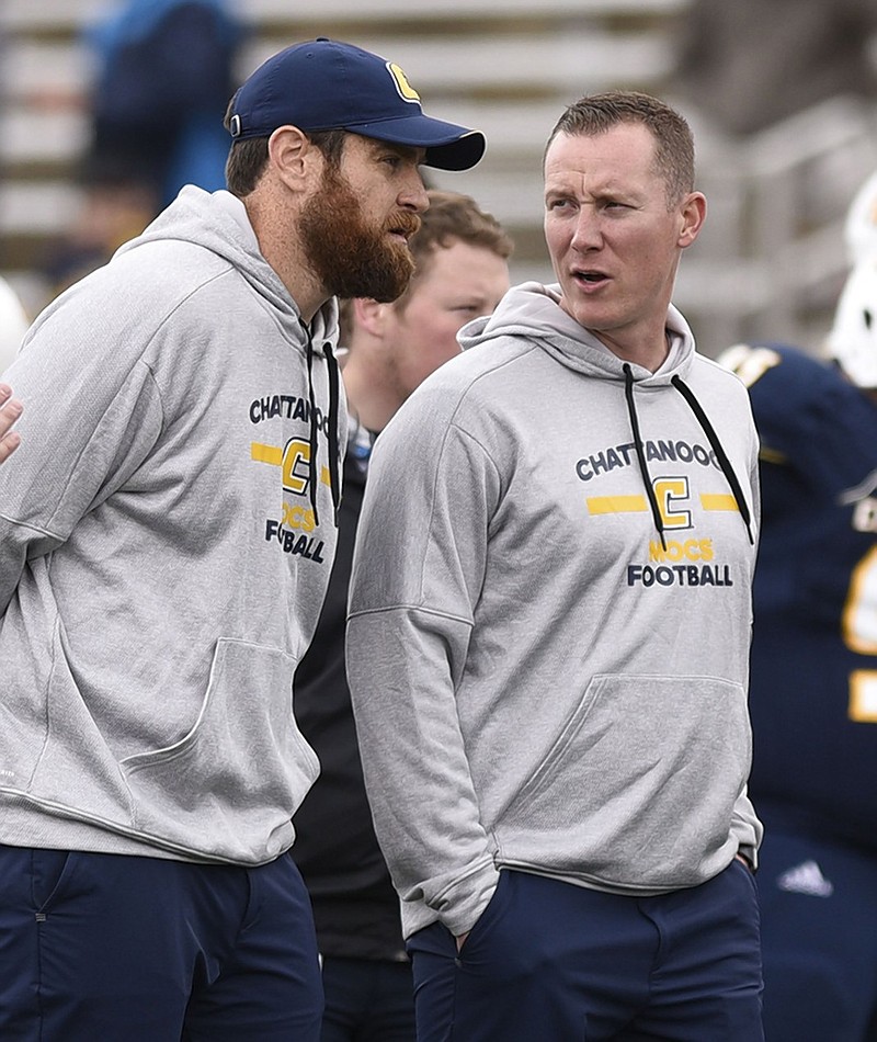 From left, UTC assistant coaches Nick Hennessey and Greg Harbaugh Jr. talk during warmups before a home game against Virginia Military Institute on Oct. 27 at Finley Stadium. Harbaugh, who coached receivers, Hennessey, who coached offensive linemen, and offensive coordinator Justin Rascati have been fired, Mocs coach Tom Arth confirmed to the Times Free Press on Wednesday.