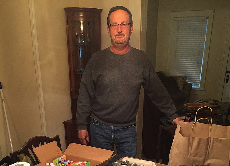 Doug Ownbey, of Brainerd, assembles backpacks filled with provisions for homeless people.