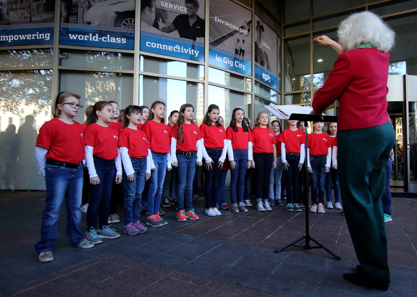 The Chattanooga Girls' Choir performs as they are directed by Delores Beery, director of the Cantilena Choir, during EPB's traditional Holiday Windows revealing Wednesday, November 21, 2018 in Chattanooga, Tennessee. The EPB Holiday Windows will remain on display through January 1.
