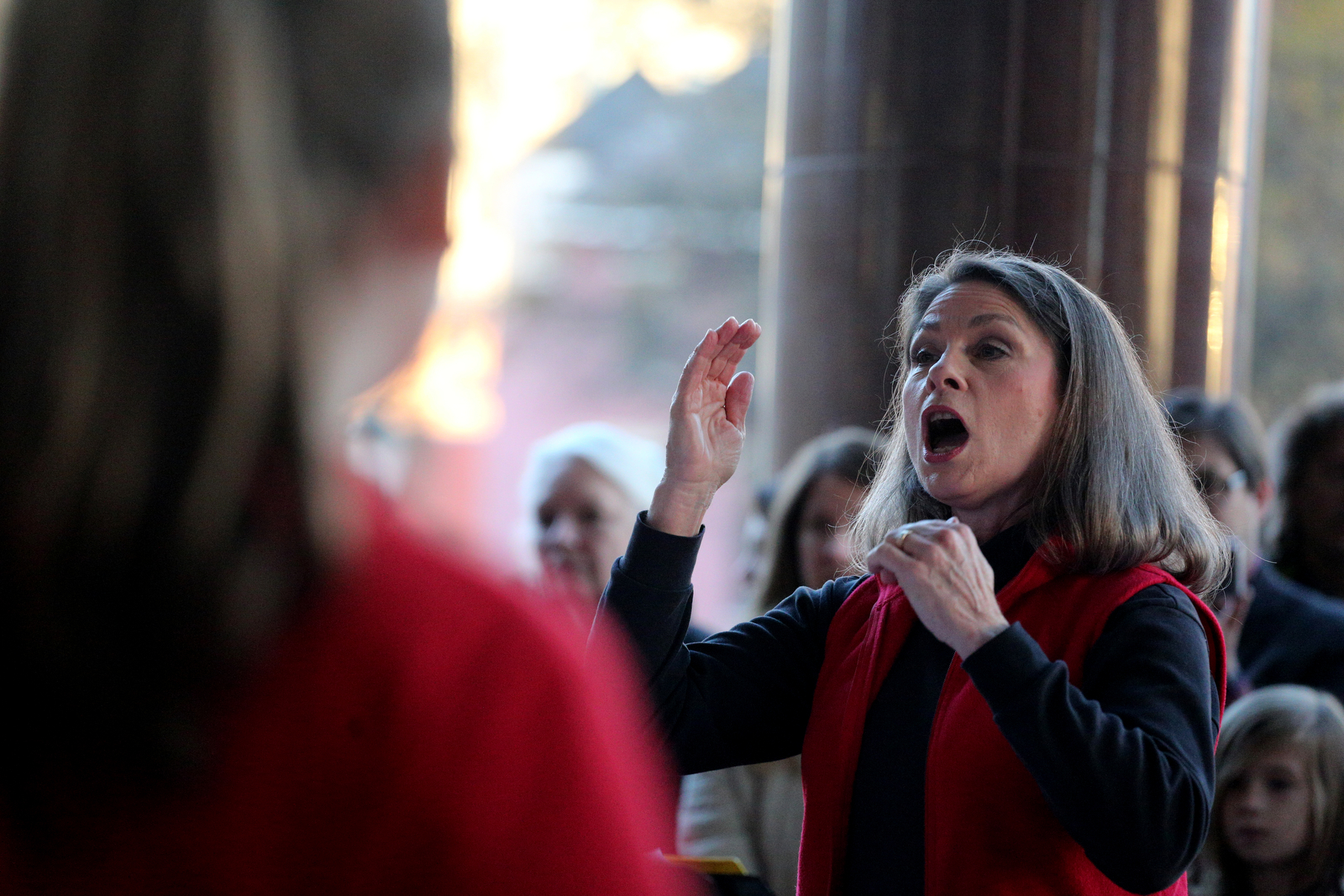 Joan Tonkinson, director of the Bella Voce Choir, leads members of the Chattanooga Girl's Choir during EPB's traditional Holiday Windows revealing Wednesday, November 21, 2018 in Chattanooga, Tennessee. The girls that performed at the event Wednesday night ranged from fourth through sixth grades.