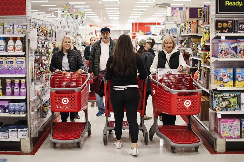 Shoppers pack an aisle during a Black Friday sale at a Target store, Friday, Nov. 23, 2018, in Newport, Ky. (AP Photo/John Minchillo)