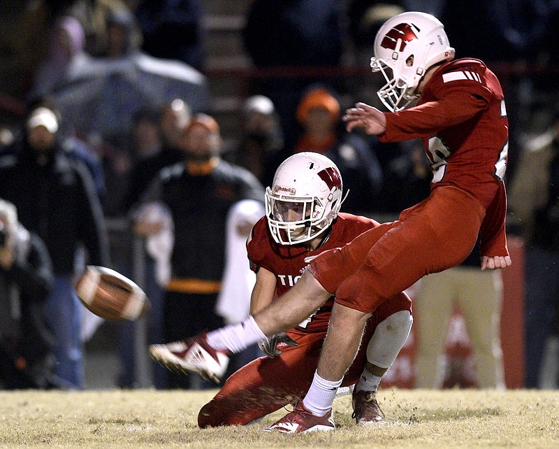 Whitwell's Evan Nunley kicks the game-winning field goal with Jaren Thames as the holder.