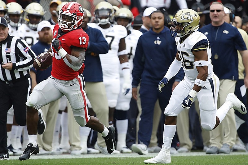 Georgia running back Elijah Holyfield carries the ball down the sideline during the Bulldogs' home win against Georgia Tech on Saturday.