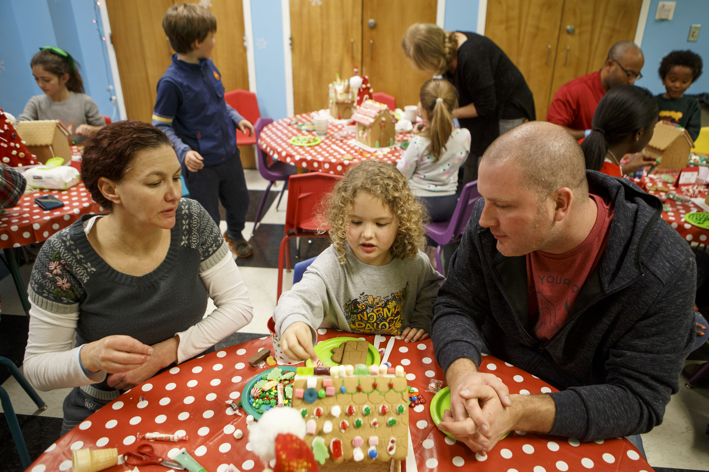 Casey, right, and Sydra Newell look on as their 4-year-old daughter Jade works on her gingerbread house during the Gingerbread Workshop at the Creative Discovery Museum on Sunday, Nov. 25, 2018 in Chattanooga, Tenn.