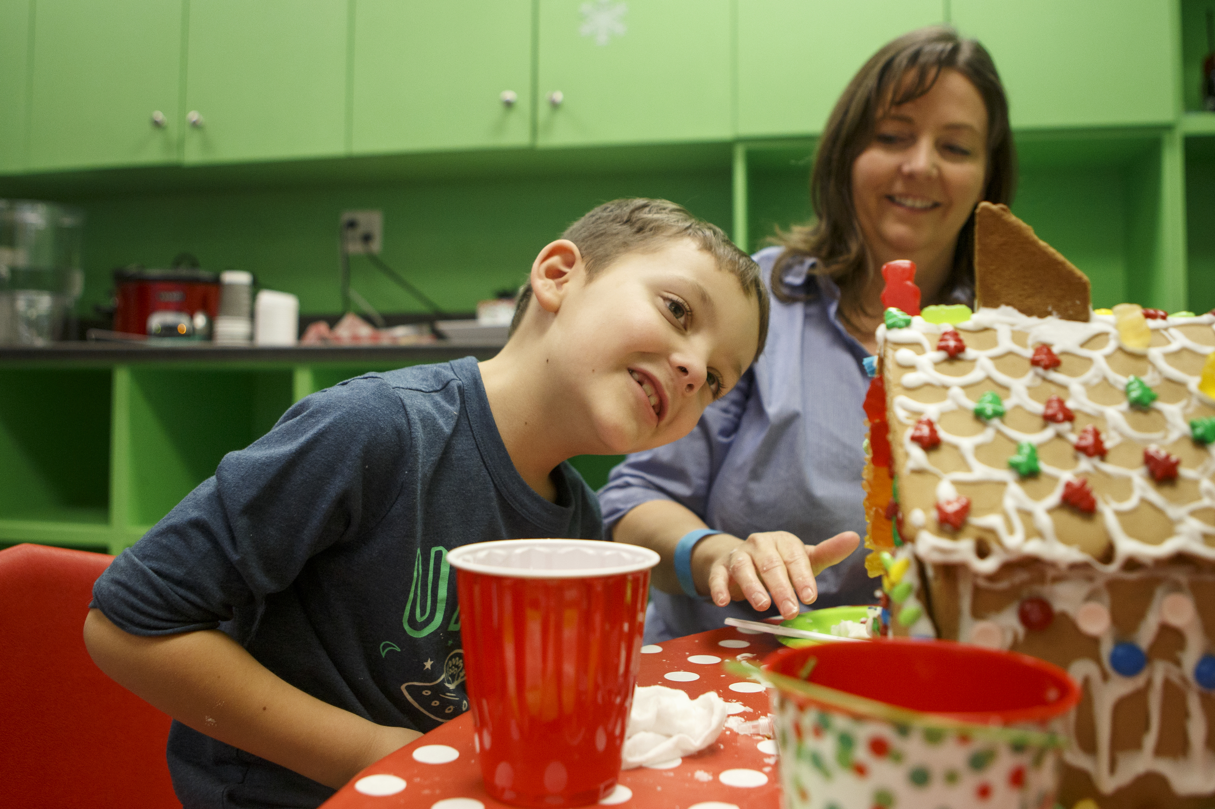Sabra Condra, right, looks on as her 7-year-old son Turner inspects his gingerbread house during the Gingerbread Workshop at the Creative Discovery Museum on Sunday, Nov. 25, 2018 in Chattanooga, Tenn.