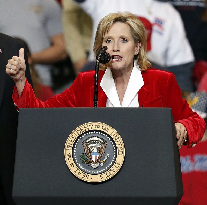 Appointed U.S. Sen. Cindy Hyde-Smith, R-Miss., with President Donald Trump, speaks during a rally Monday, Nov. 26, 2018, in Biloxi, Miss. Trump encouraged voters to support Hyde-Smith's runoff race against Democrat Mike Espy. (AP Photo/Rogelio V. Solis)

