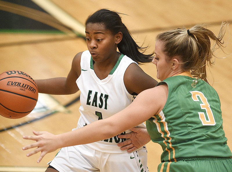 East Hamilton's Anaya Evans (1) dribbles past the defense of Rhea County's Maddie Smith (3).  The East Hamilton Hurricanes hosed the Rhea County Eagles in girl's TSSAA basketball action on November 27, 2018. 
