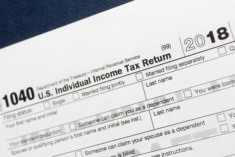 FILE- This July 24, 2018, file photo shows a portion of the 1040 U.S. Individual Income Tax Return form for 2018 in New York. The Child Tax Credit changed considerably in 2018. (AP Photo/Mark Lennihan, File)