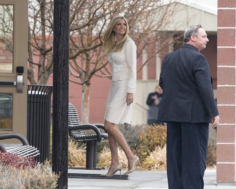 Ivanka Trump looks back at supports and protestors as she enters Wilder Elementary School in Wilder, Idaho, Tuesday, Nov. 27, 2018. Ivanka Trump, President Donald Trump's daughter and White House adviser, and Apple CEO Tim Cook visited the heavily Hispanic Idaho school district Tuesday to trumpet her workforce development initiative promoting science, technology, engineering and math, White House officials said. (AP Photo/Otto Kitsinger)