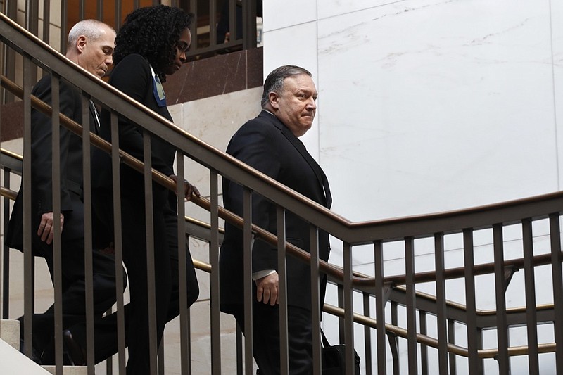 Secretary of State Mike Pompeo, right, arrives for a closed door meeting with Senators about Saudi Arabia, Wednesday, Nov. 28, 2018, on Capitol Hill in Washington. Senators who have grown increasingly uneasy with the U.S. response to Saudi Arabia after the killing of journalist Jamal Khashoggi are set to grill top administration officials Wednesday at a closed-door briefing that could determine how far Congress goes in punishing the longtime Middle East ally. (AP Photo/Jacquelyn Martin)