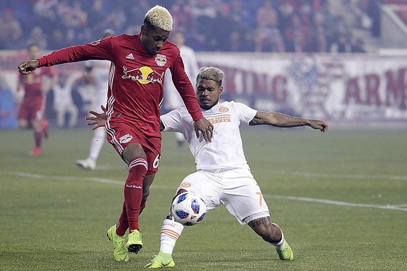 New York Red Bulls defender Michael Murillo, left, clears the ball as Atlanta United FC forward Josef Martinez attacks during the first half of Thursday night's match in Harrison, N.J. It was the second half of their MLS Eastern Conference final, and while New York won the match 1-0, Atlanta won the two-leg final 3-1 on aggregate scoring.