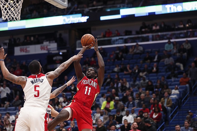 New Orleans Pelicans guard Jrue Holiday (11) shoots against Washington Wizards forward Markieff Morris (5) in the second half of an NBA basketball game in New Orleans, Wednesday, Nov. 28, 2018. The Pelicans won 125-104. (AP Photo/Gerald Herbert)