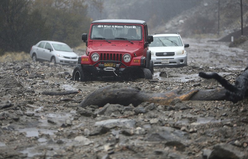 A mudslide trapped several vehicles along Valley of the Falls Drive in Forest Falls in San Bernardino County, Calif., on Thursday, Nov. 29, 2018. Forecasters say the weather system that has been raining all day on Southern California has developed instability and may produce thunderstorms. Mud and rock slides have also closed two mountain highways northeast of Los Angeles. (Stan Lim/The Orange County Register via AP)

