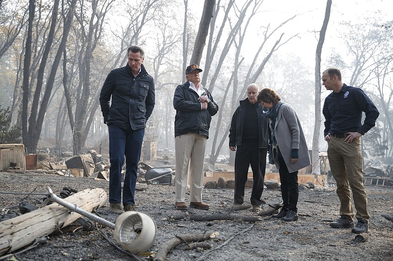 FILE — President Donald Trump tours fire-ravaged homes in Paradise, Calif., in mid-November, but he dismissed the government's newest report on the economic cost of climate change, which included predictions of more devastating wildfires. (Tom Brenner/The New York Times)