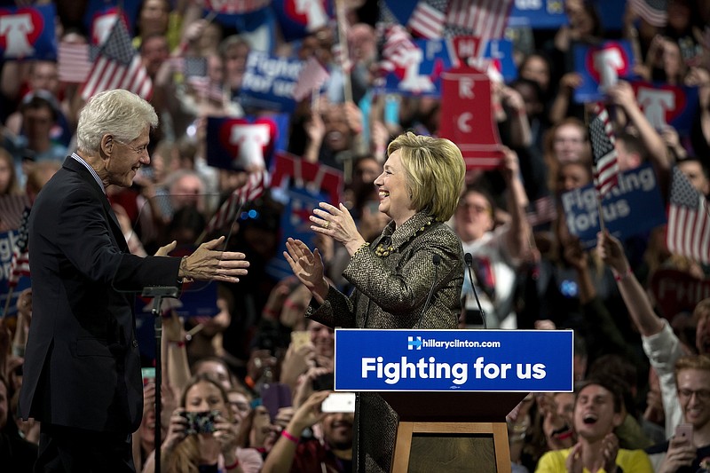 Hillary Clinton walks to embrace her husband, Bill, during a primary rally in Philadelphia during the 2016 presidential campaign.