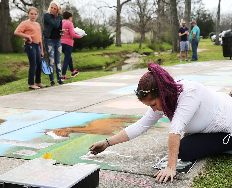 Meg Mitchell creates a drawing with sidewalk chalk to illustrate different parts of Fort Oglethorpe during a Thriving Communities Initiative interactive art walk pop-up at Gilbert-Stephenson Park in March. The park will soon see art displayed more permanently thanks to a grant from the Lyndhurst Foundation.