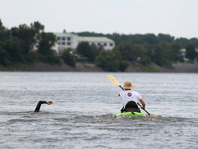 Andreas Fath, a world-record-holding endurance swimmer and professor of Medical and Life Sciences at Furtwangen University in Germany, swims alongside Juri Jander down the Tennessee River Friday, Aug. 4, 2017, in Chattanooga, Tenn. Jander is a student where Fath teaches who is doing his thesis on micro-plastics. 