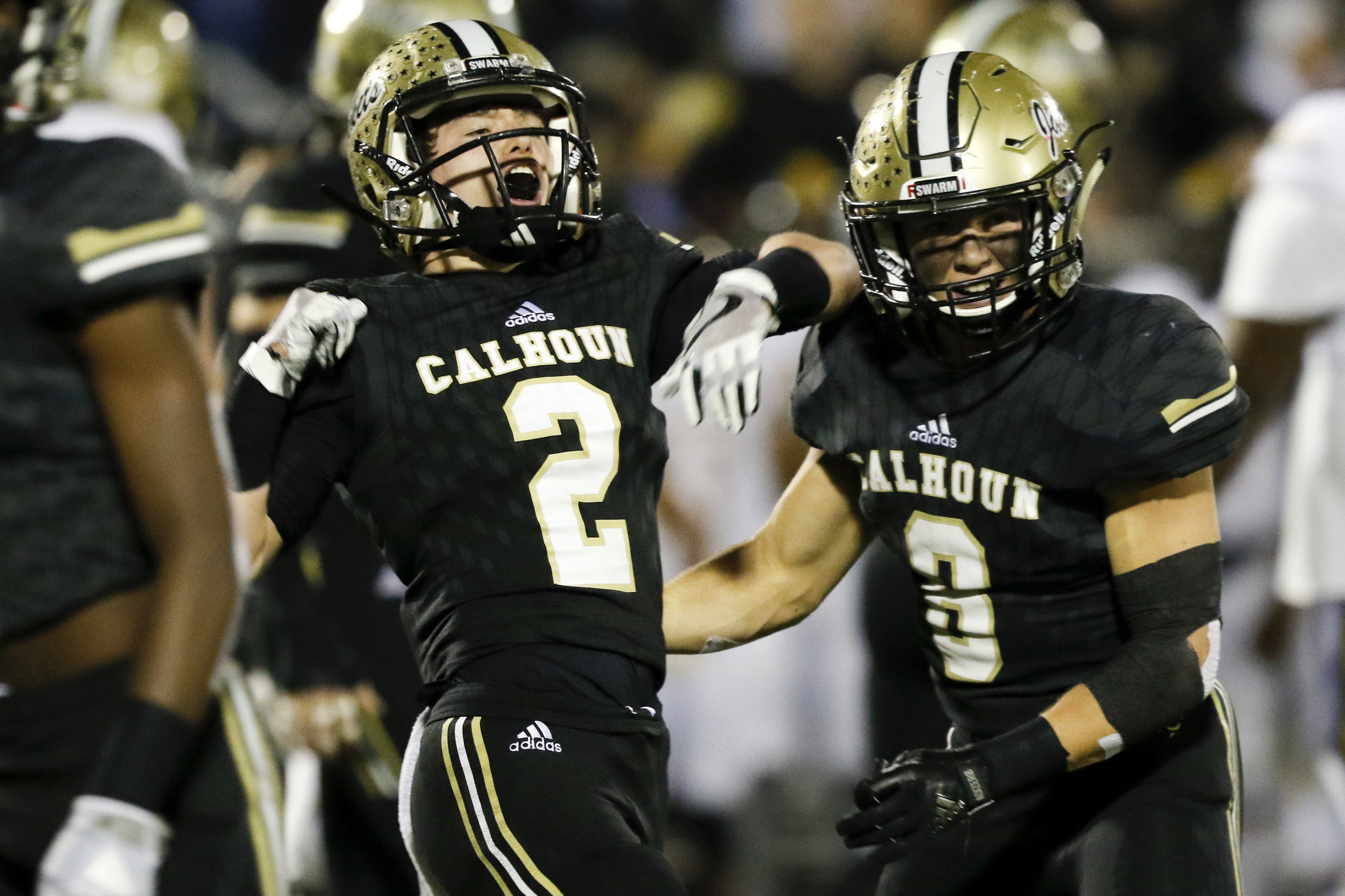 Calhoun's Payton Morrow (2) and Tripp Hoblitzell (8) celebrate after Morrow's sack against Peach County during the GHSA Class AAA semifinals at Phil Reeve Stadium on Friday, Nov. 30, 2018 in Calhoun, Ga.