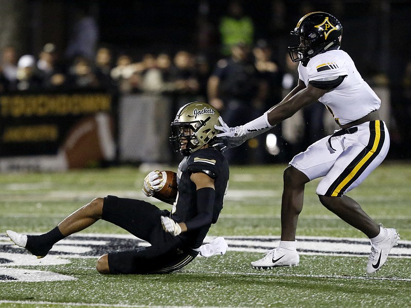 Calhoun's Luke Moseley slides down in front of Peach County's Keyshawn Cobb during Friday night's GHSA Class AAA state semifinal at Phil Reeve Stadium in Calhoun, Ga. Peach County won to advance to the GHSA Class AAA title game against Cedar Grove.