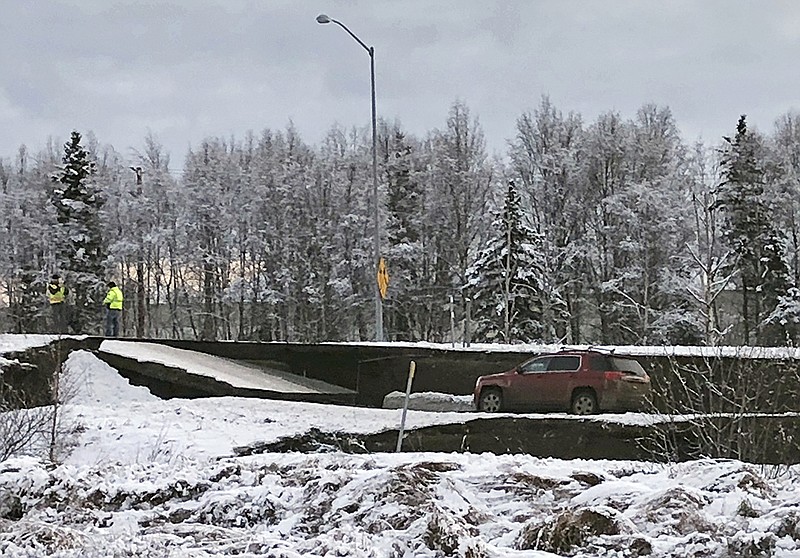 A car is trapped on a collapsed section of the offramp off of Minnesota Drive in Anchorage, Friday, Nov. 30, 2018. Back-to-back earthquakes measuring 7.0 and 5.8 rocked buildings and buckled roads Friday morning in Anchorage, prompting people to run from their offices or seek shelter under office desks, while a tsunami warning had some seeking higher ground. (AP Photo/Dan Joling)

