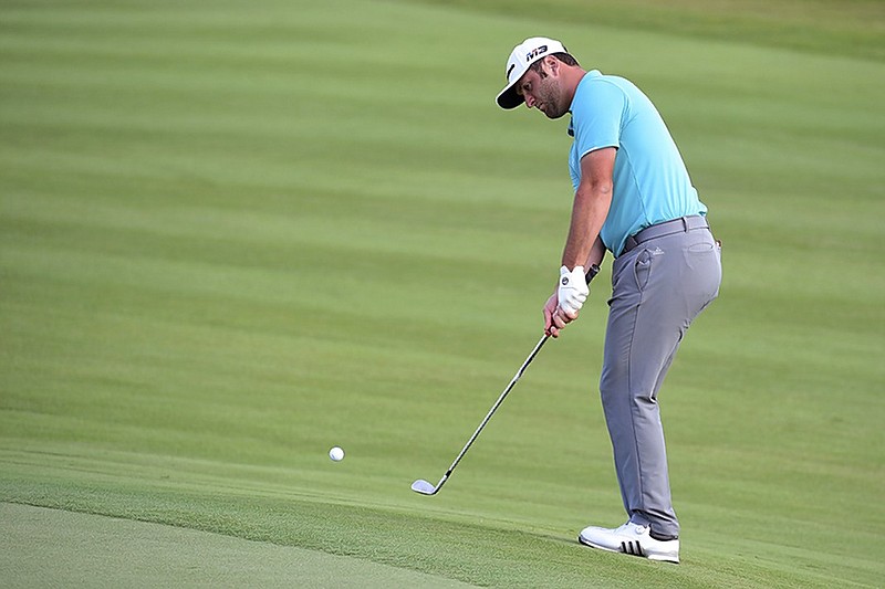 Jon Rahm chips onto the 15th green at Albany Golf Club in Nassau, Bahamas, during Thursday's first round of the Hero World Challenge. Rahm shot a 9-under-par 63 in Friday's second round and shared the 36-hole lead with Henrik Stenson at 10-under 134 overall.