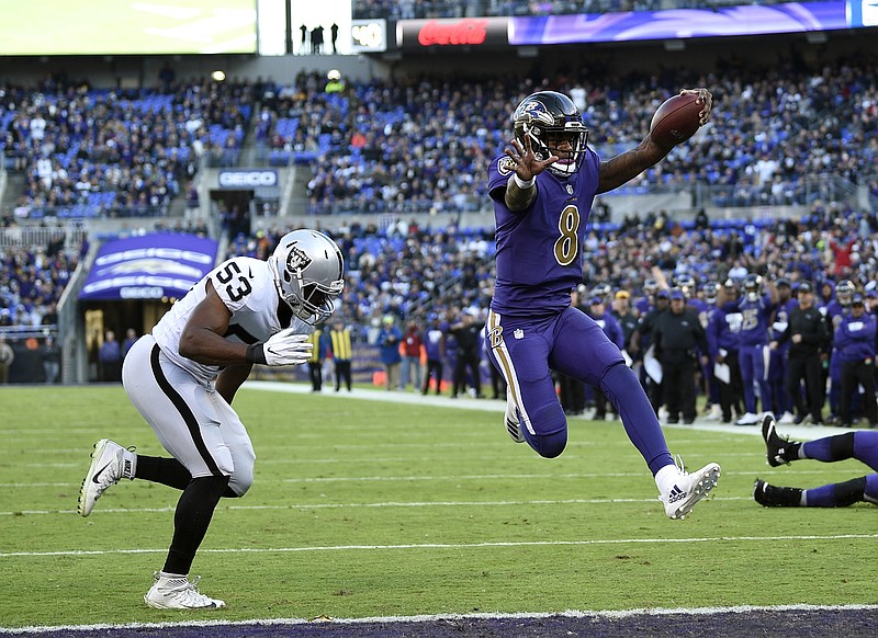 Baltimore rookie quarterback Lamar Jackson scores a touchdown in front of Oakland Raiders linebacker Jason Cabinda during the Ravens' 34-17 home win last Sunday. Jackson could make his third straight start today as the Ravens visit the Atlanta Falcons, but longtime starter Joe Flacco has been cleared to play after battling a right hip injury.