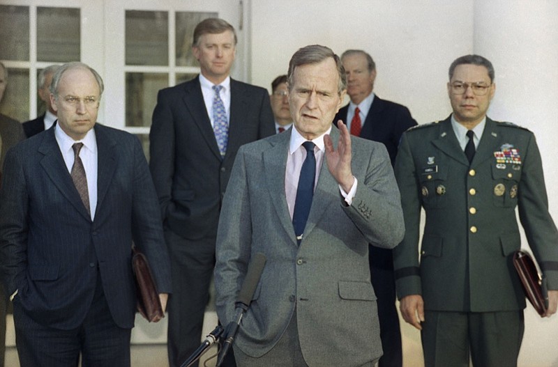 FILE - In this Feb. 11, 1991, file photo, President George H.W. Bush talks to reporters in the Rose Garden of the White House after meeting with top military advisors to discuss the Persian Gulf War. From left are, Defense Secretary Dick Cheney, Vice President Dan Quayle, White House Chief of Staff John Sununu, the president, Secretary of State James A. Baker III, and Joint Chiefs Chairman Gen. Colin Powell. Bush died at the age of 94 on Friday, Nov. 30, 2018, about eight months after the death of his wife, Barbara Bush. (AP Photo/Ron Edmonds, File)

