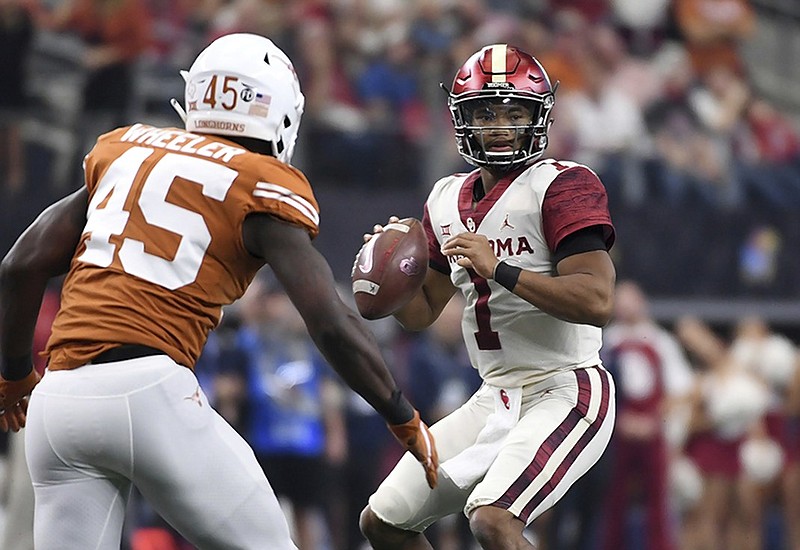 Oklahoma quarterback Kyler Murray looks to pass as Texas linebacker Anthony Wheeler closes in during the first half of the Big 12 football championship game on Saturday at AT&T Stadium in Arlington, Texas.