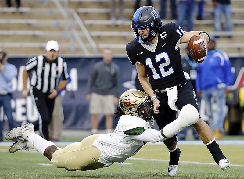 MTSU quarterback Brent Stockstill (12) is sacked by UAB linebacker Tre' Crawford for a 12-yard loss in the second half of the Conference USA championship game Saturday in Murfreesboro, Tenn.