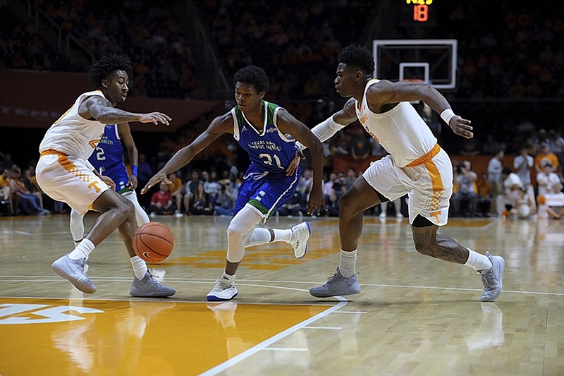 Texas A&M-Corpus Christi's Tre Gray, center, tries to dribble past Tennessee's Jordan Bowden, left, and Admiral Schofield during Sunday's game at Thompson-Boling Arena in Knoxville.