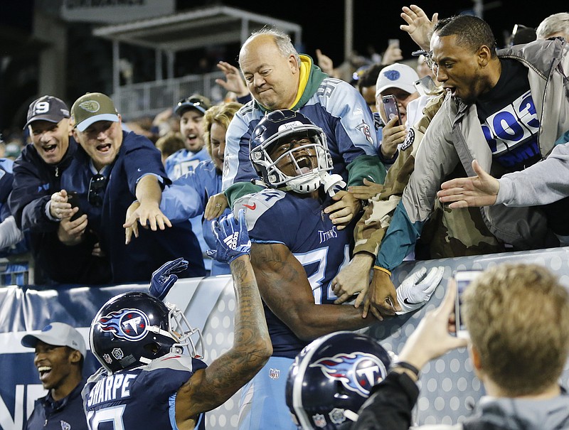 Tennessee Titans wide receiver Corey Davis jumps to celebrates with fans after scoring the game-winning touchdown against the New York Jets on Sunday in Nashville.